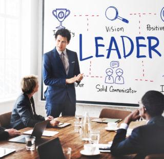 Director at conference table with white board