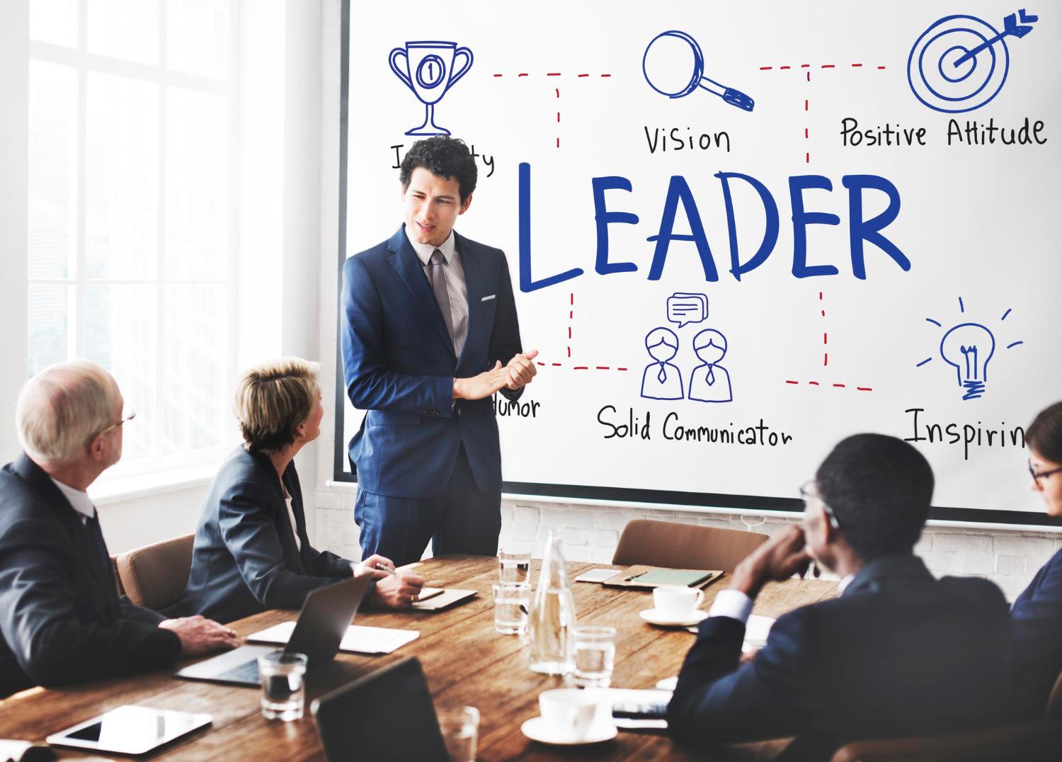 Director at conference table with white board