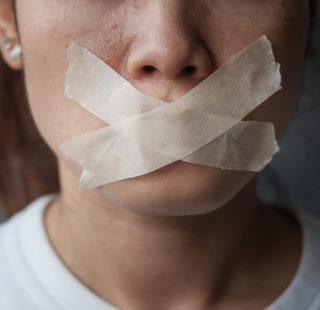 Woman with sealed mouth