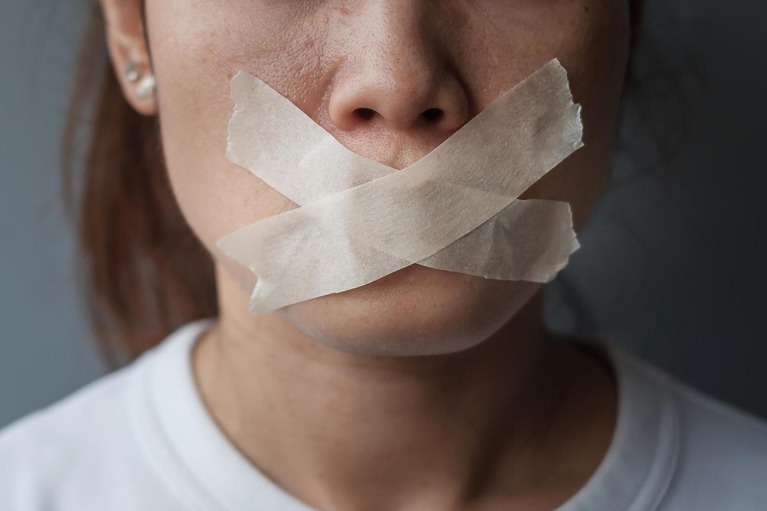 Woman with sealed mouth